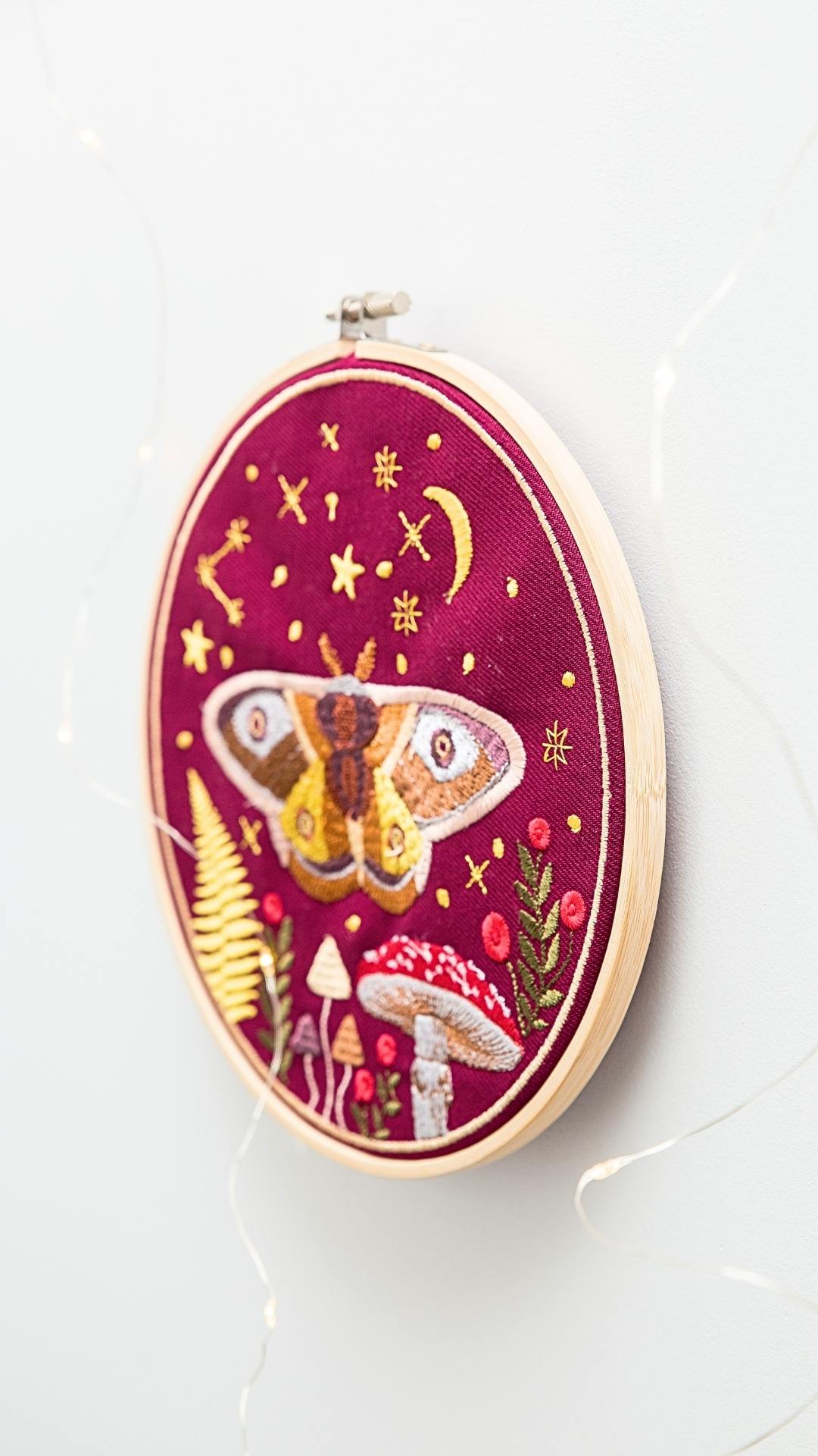 Haft w tamborku, magiczna ćma na tle nieba